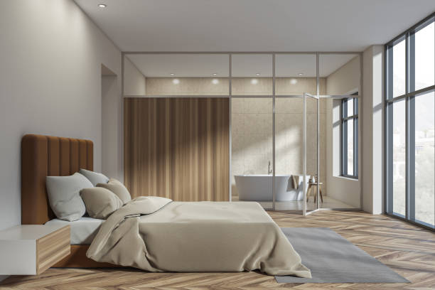 istock Light bedroom interior with bathtub and window with countryside 1369280921