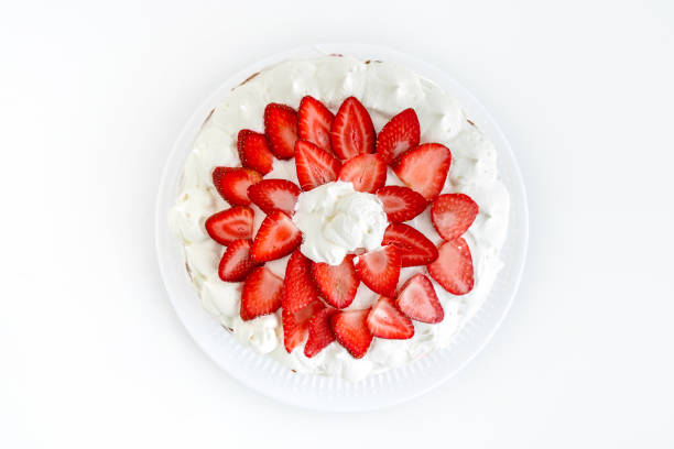 Cake with strawberries and mascarpone on a white wall background. Delicious dessert