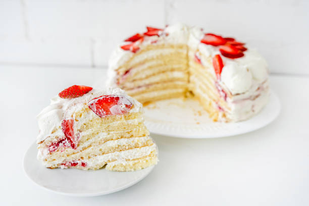 istock Delicious cake with cream cheese and strawberries. Beautiful serving on a white brick background 1369282698