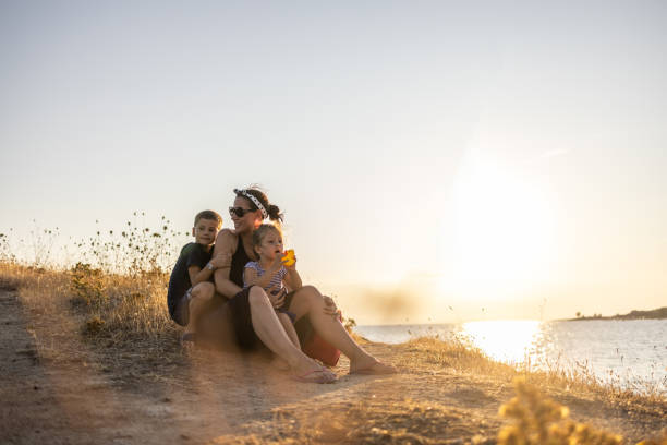 istock Mother spending time on beach with her two kids 1369283825