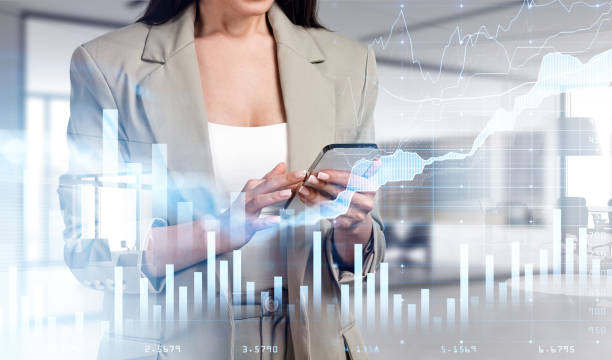 istock Businesswoman with phone in hands, graph changes with numbers 1369284004
