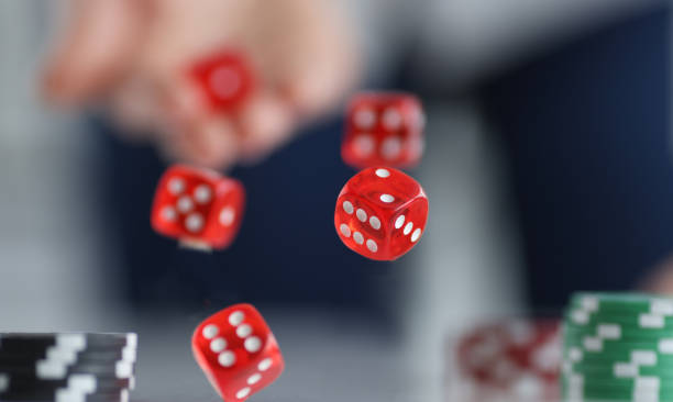 istock Red dice flying over casino chips closeup 1369284303