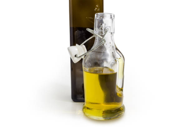 istock Two different bottles of olive oil on a white background 1369285170