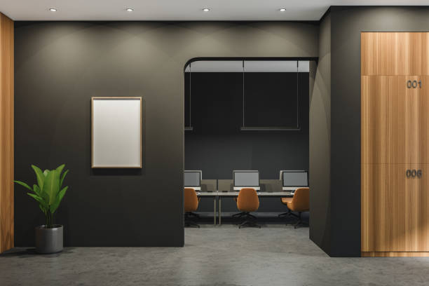istock Dark office room interior with empty white poster, desktops 1369285822