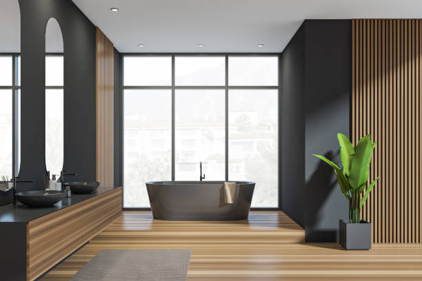 istock Dark bathroom interior with bathtub, panoramic window with town view 1369285887