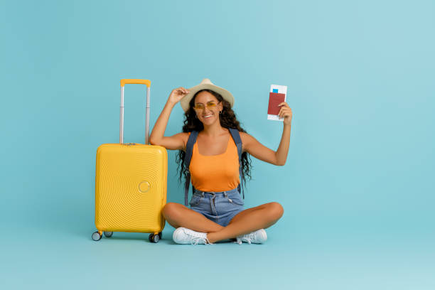 istock Happy woman going traveling 1369286423