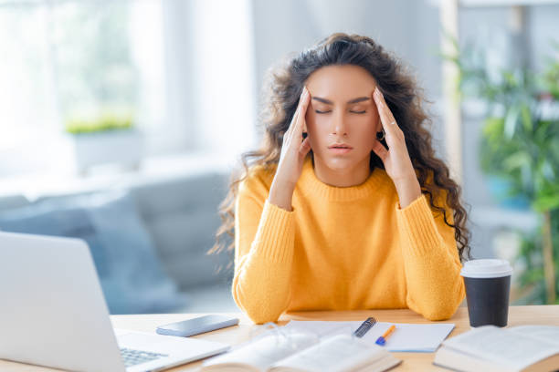 istock Young woman studying and having a head ache 1369286880