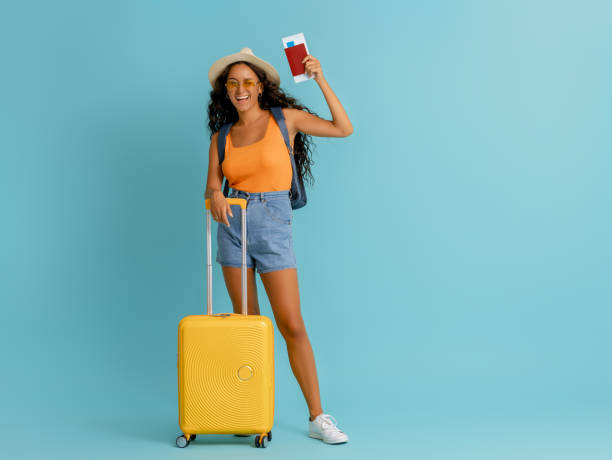 istock Happy woman going traveling 1369287118