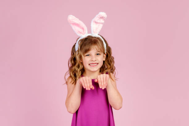 istock Cute little girl acting like rabbit during Easter celebration 1369287492