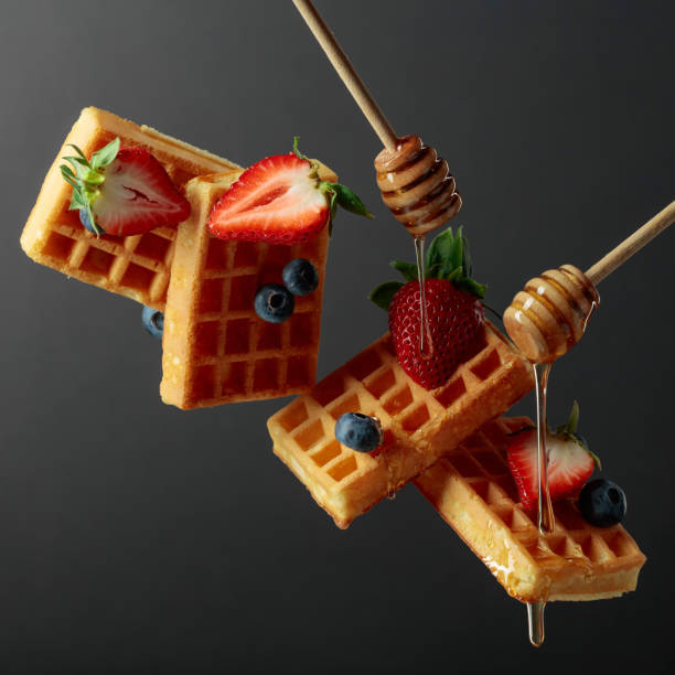 istock Waffles with blueberries, strawberries, and honey. 1369289196