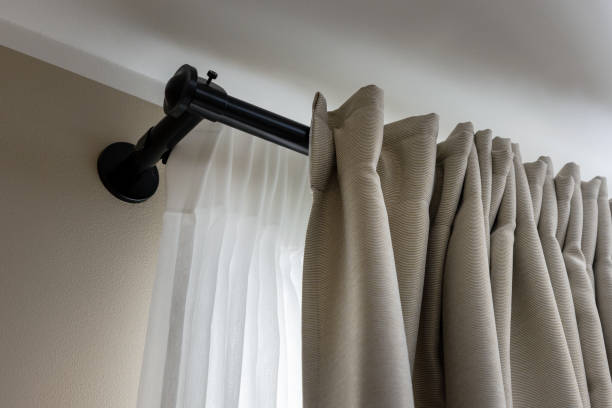 double layer curtains on black rod in living room stock photo