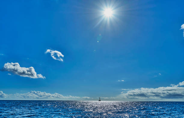 sun and sea view with a boat on the horizon.On the atlantic ocean