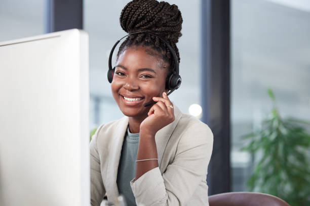istock Portrait of a young call centre agent working on a computer in an office 1369291049
