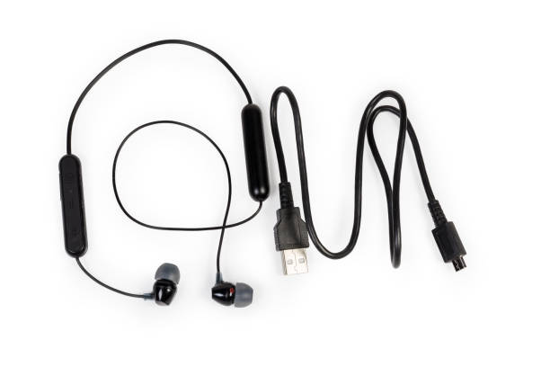 istock Wireless in-ear earphones and charging cable on white background 1369291142