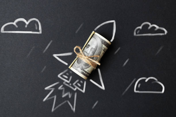 Rocket with a roll of dollars. The concept of financial success and wealth growth in business. stock photo