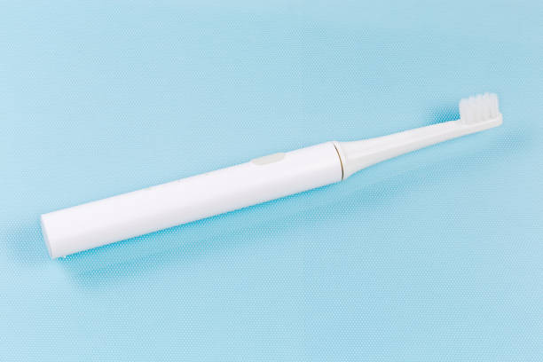 istock Electric rechargeable toothbrush on a blue surface 1369291234