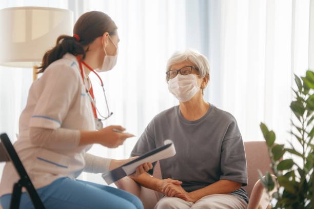 istock Doctor and senior woman wearing facemasks 1369292552