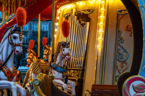 Sopot, Poland - January 19, 2022: Shiny festive children's carousel with toys at the Monte Cassino square in Sopot, Poland. Children's playground during winter holidays. Traditional Christmas entertainment and decorations