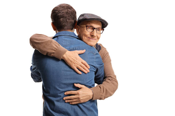 istock Elderly and young man hugging each other isolated on white background 1369296623
