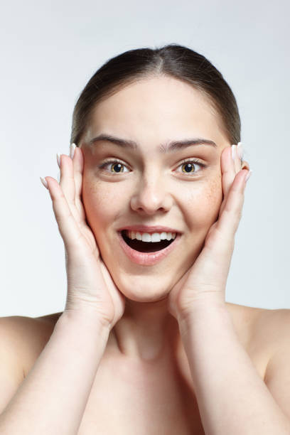 istock Girl with hands near face  posing on white background. 1369297659