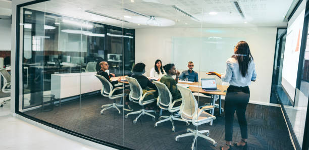 istock Creative businesswoman giving a presentation in a boardroom 1369298030