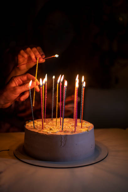 istock light candles together on a birthday cake, party 1369298065
