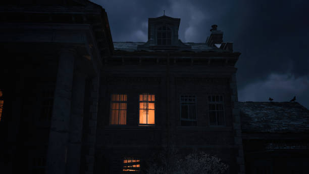 istock Illuminated windows of a spooky abandoned manor under a dark cloudy sky. 3D render. 1369299335