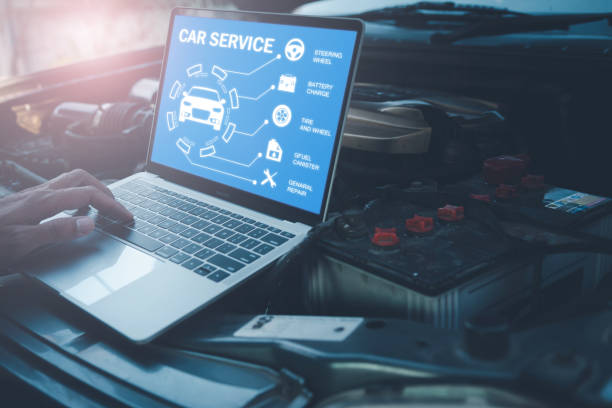 istock Mechanic with laptop near car engine. Modern car diagnostic program on screen. Car service concept. 1369299824