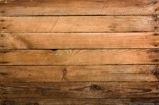 Weathered old wooden planks background with nails top view.
