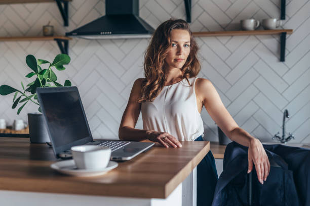 istock Woman working at home in the kitchen. 1369302033