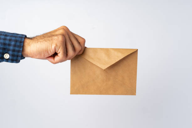 istock Male hands holding an envelope with a wax seal 1369302760