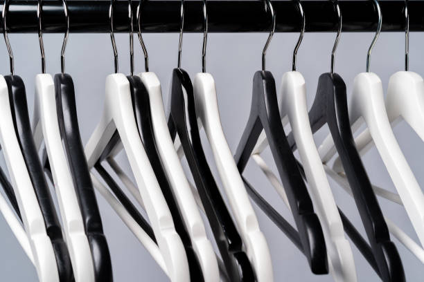 istock Metal rack with clothes hangers on grey background 1369302964