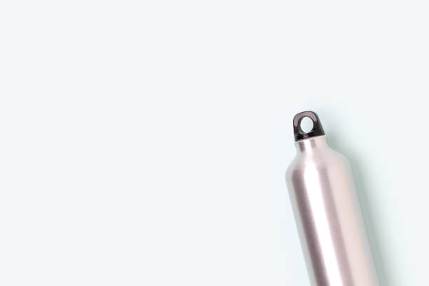 istock Minimal concept with metallic bottle on a blue background. 1369303248