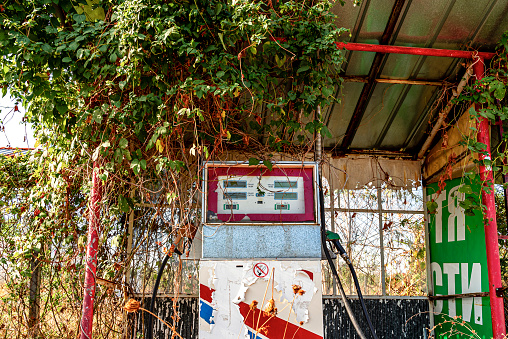 Old abandoned overgrown rusty gas station in Bulgaria. The photo is taken with Sony A7s3 camera.