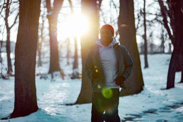 Man running in park during winter day