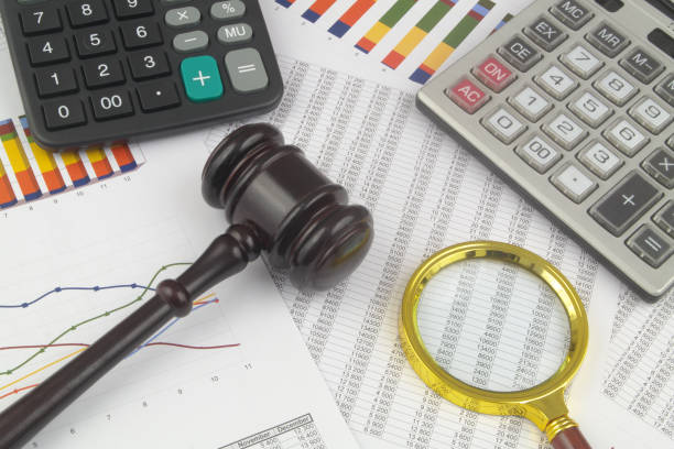 istock Arbitration concept, wooden judge gavel and calculators on financial documents. 1369304573