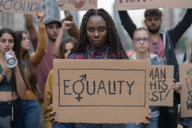 istock Multiracial group of young people walking together protesting for equality against racism 1369305064