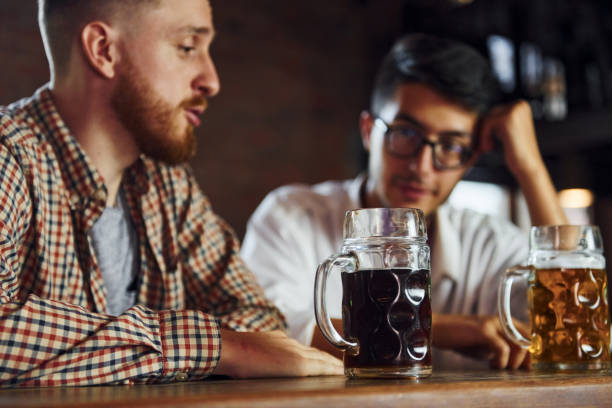 istock People in casual clothes sitting in the pub and having conversation 1369305292
