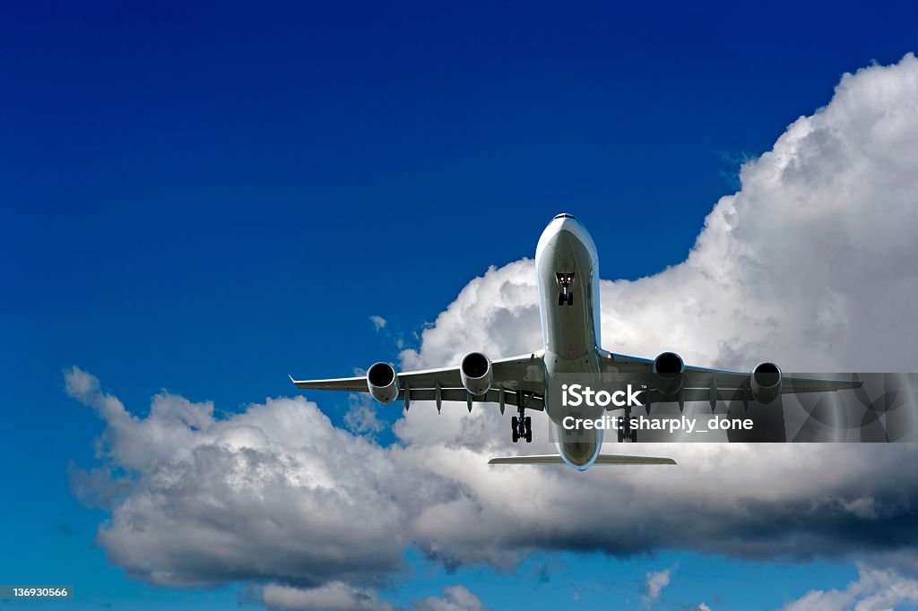 XXL jet airplane landing in cloudy sky jet airplane landing in bright cloudy sky (XXL) Airplane Stock Photo