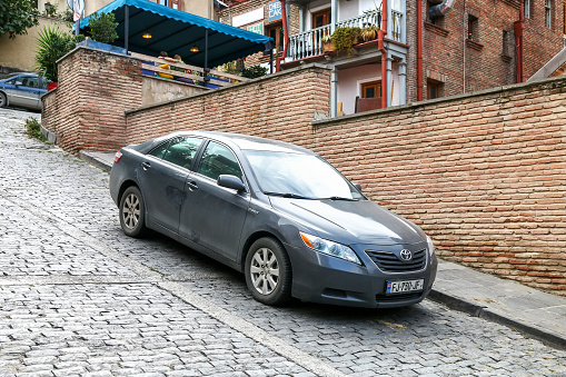 Tbilisi, Georgia - October 10, 2021: Grey car Toyota Camry in a city street.