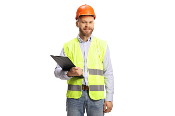 istock Young male engineer with a hardhat holding a clipboard 1369306295