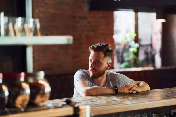 istock Young man in casual clothes sitting in the pub 1369307073