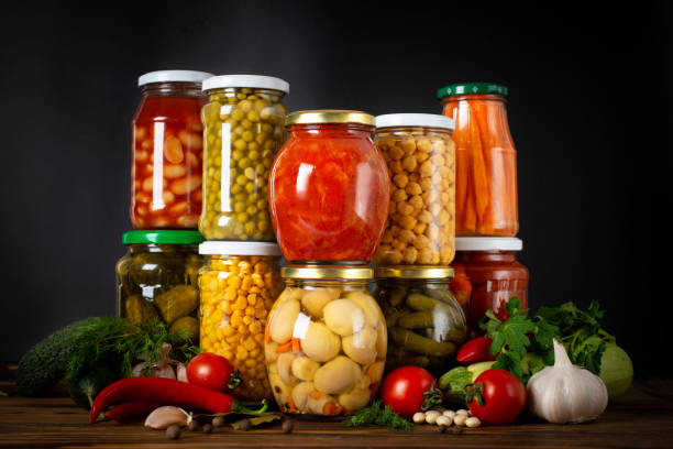 istock Jars with pickled vegetables and fruity compotes. Preserved food 1369307907