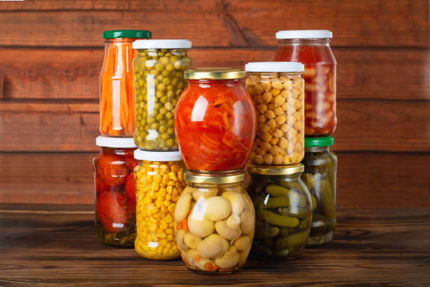 istock Jars with pickled vegetables and beans on wooden background 1369307993