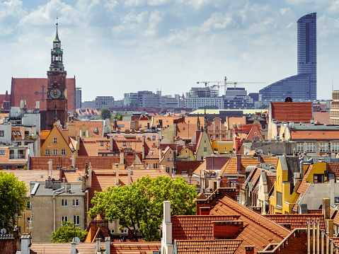 view from above on orange tiled rooftops of old medieval buildings of european polish city of Wroclaw