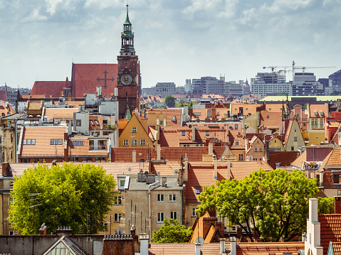 view from above on orange tiled rooftops of old medieval buildings of european polish city of Wroclaw
