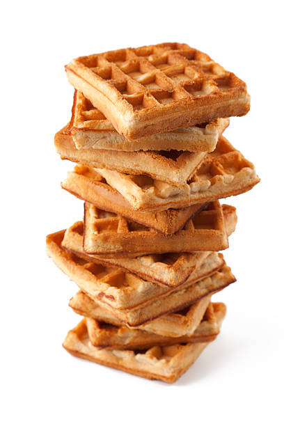 Stack of multiple waffles on a white background stock photo