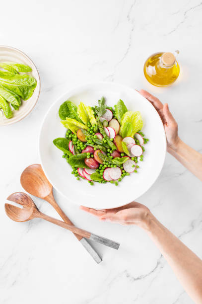 istock Green vegetarian potato and asparagus salad, top-down view 1369309793
