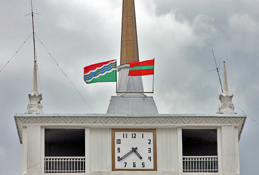 Transnistria / Moldova - Tiraspol - The official flags of Tiraspol city and the unrecognized state Transnistria on the tower of Tiraspol city council building in the caital downtown