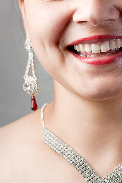 An elegant gold necklace with turquoise topaz lies inside a red gift box